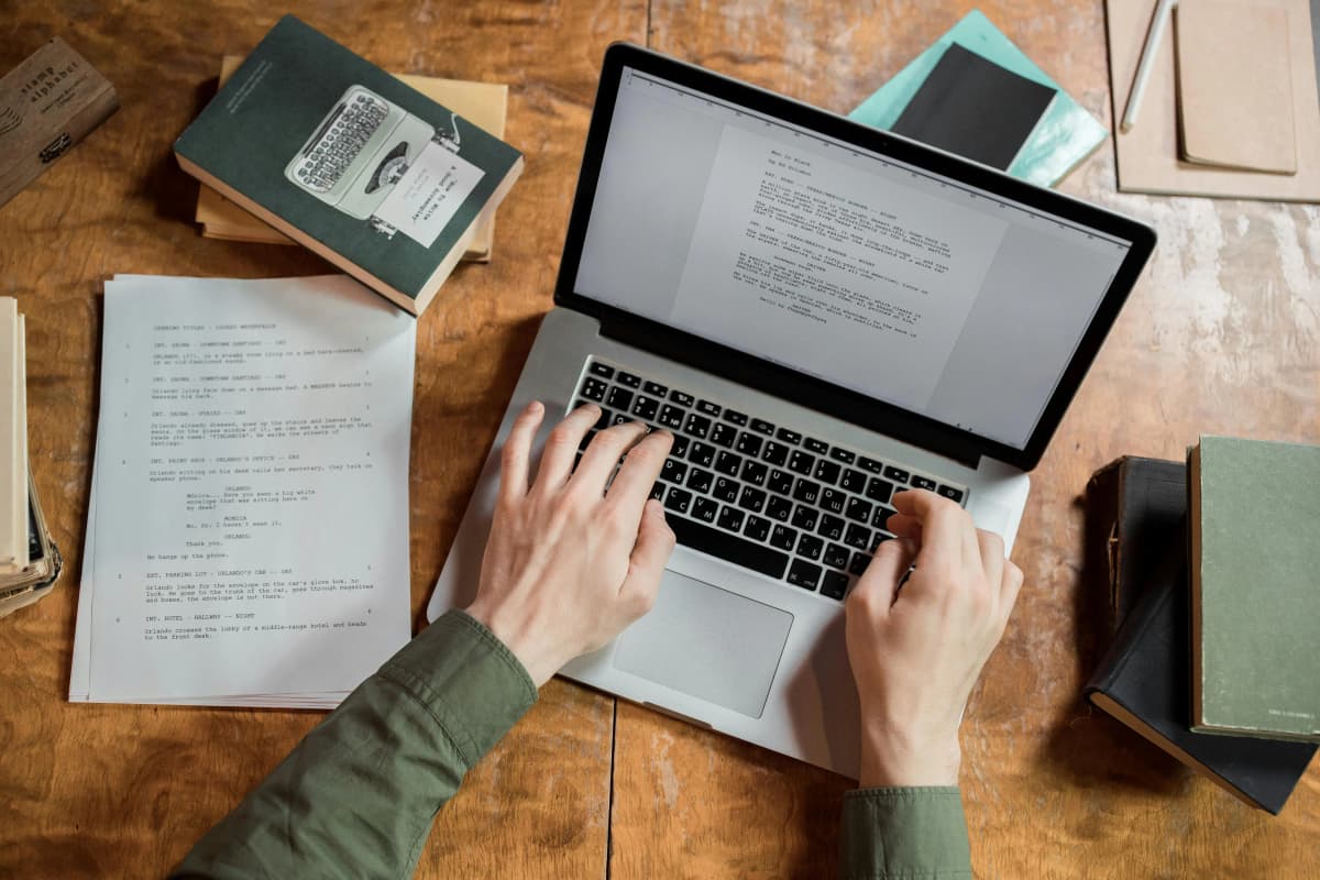 Person writing on a laptop